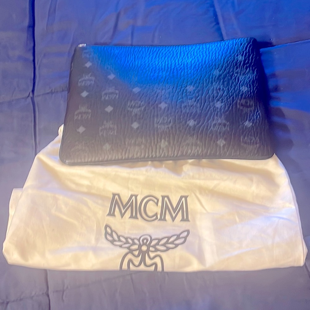 This is a MCM crossbody bag black with the dust bag and strap enclosed